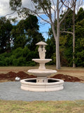 2 tier Italian fountain with spring time and traditional pond surround